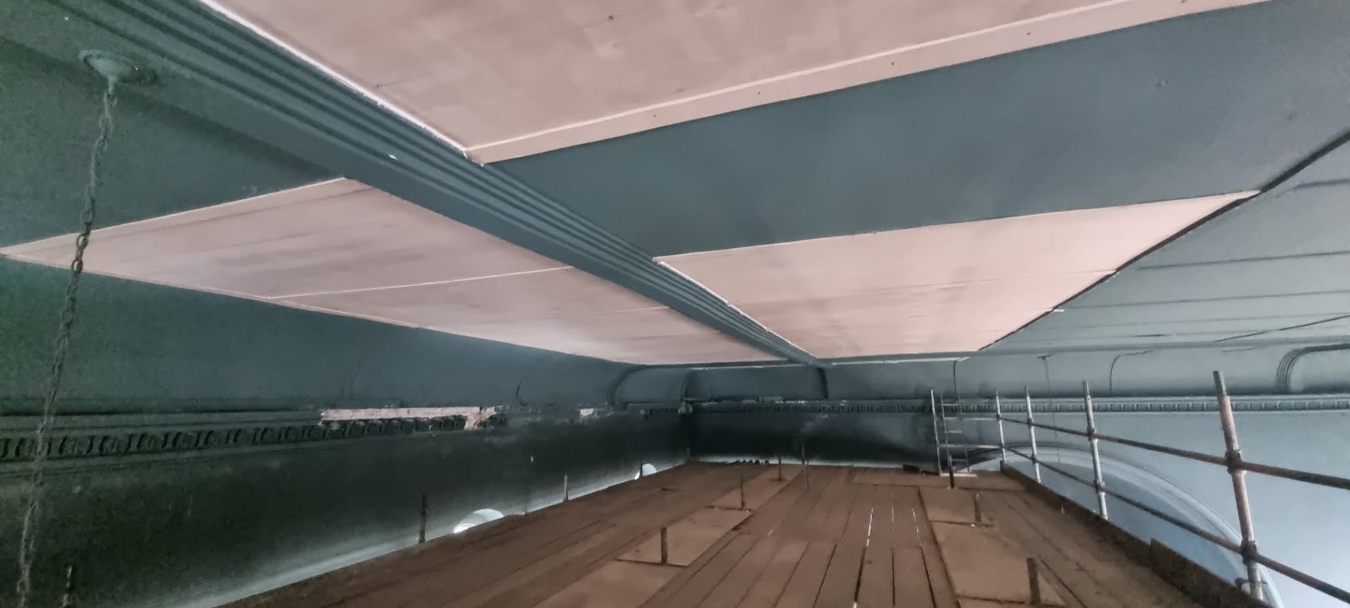New ceiling boards fitted between the painted beams of St Ouen's Methodist Church